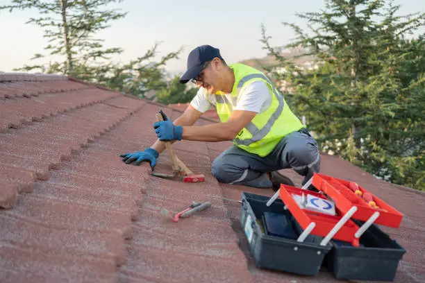 Roofer buider worker ensuring roof maintenance